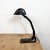 Vintage bankers bauhaus table lamp made in Germany during the 1930s. It features a black metal iron shade with white...