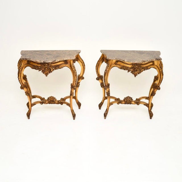 A stunning pair of antique French gilt wood marble top console tables, dating from around the 1950’s. They are beautifully...