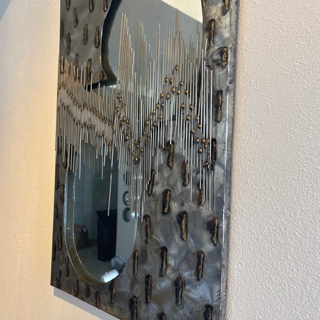 1960’s-70’s vintage Brutalist artisan wall mirror featuring torched metal framing with expressive welded rods.