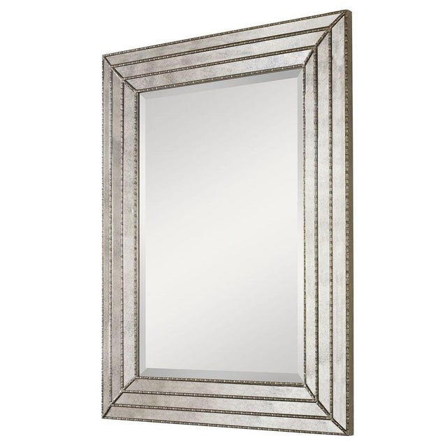 This stunning mirror features a frame made of antiqued mirror layered inlays with Venetian burnished silver details....