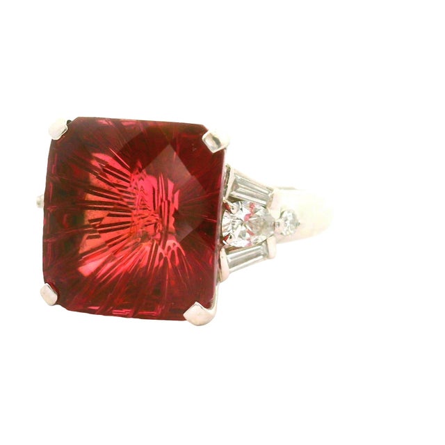 Experience the elegance of this 8.95 carat pink tourmaline ring. The fantasy-cut tourmaline captivates with its vibrant...