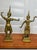 A matched pair of vintage brass statues depicting Thai dancers in traditional ceremonial poses. These figures capture the...