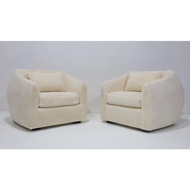 We have updated these excpetionally comfortable lounge chairs in a Holly Hunt plush fabric. Reminiscent of the Jean Royere...