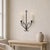 A graceful vintage wrought iron wall candleholder made in Germany. The hand-worked black iron has a clean, sculptural...