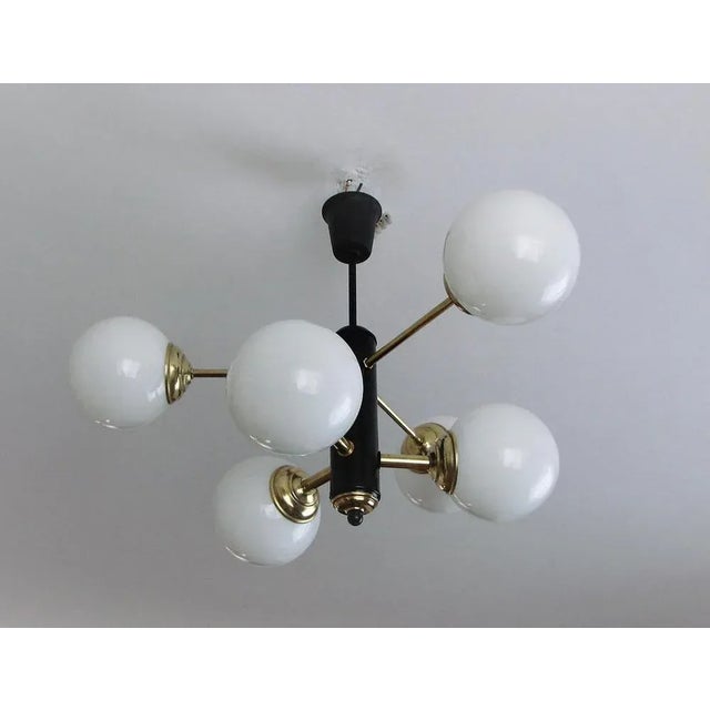Modernist chandelier, 1970s. It was made of brass, metal and glass. Dimensions: height 50cm wide 65cm head 65cm Up to 250V...