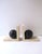 A substantial pair of beige and black marble bookends, Postmodern / Art Deco Revival period, circa late‑20th century. The...