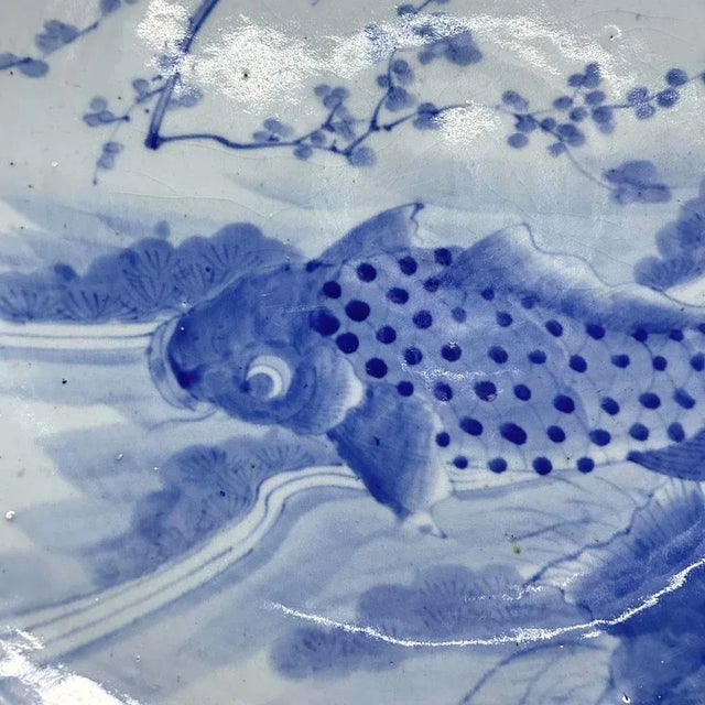 Beautifully decorated porcelain plate from the Meiji period featuring the image of a swimming carp (koi) and blossoms...