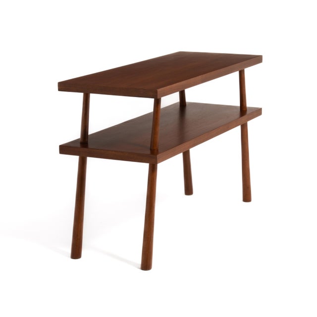 A walnut console or hall table made by the Widdicomb Furniture Company. Designed by T.H. Robsjohn-Gibbings and made in...