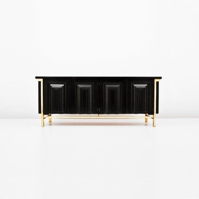This stunning and distinct black lacquered and brass detail credenza or sideboard by Mastercraft. Meticulous attention to...