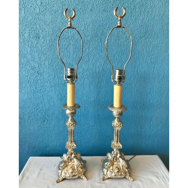 Superb quality and detail with beautiful repousee work. The elaborate candlesticks have been converted to lamps. They are...