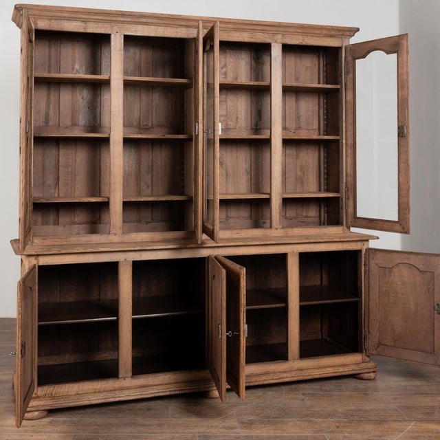 Large 20th century French bookcase, crafted in oak and bleached to create a lighter, softer patina suited to a range of...