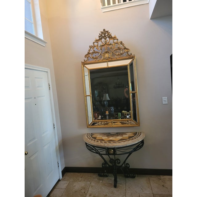 This striking Maitland‑Smith demi‑lune console table blends sculptural ironwork with a richly patterned stone top,...
