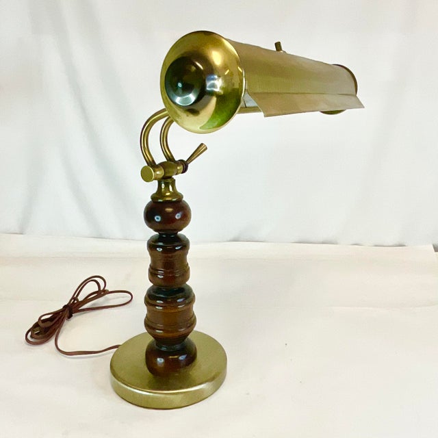 This is a great vintage Desk Lamp. We love the old-style articulating angled brass neck and the rich walnut stem of the...
