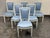 Design Plus Gallery presents a Set of Six Louis XVI Style Dining Side Chairs. The set of chairs have a white washed frame...