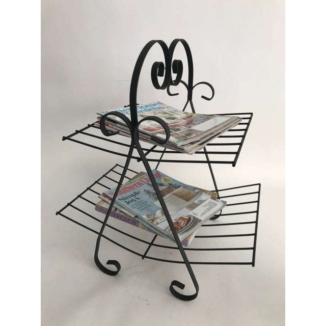 Mid Century metal magazine rack with scroll feet. This retro rack is perfect for magazines or use as a towel rack in a...