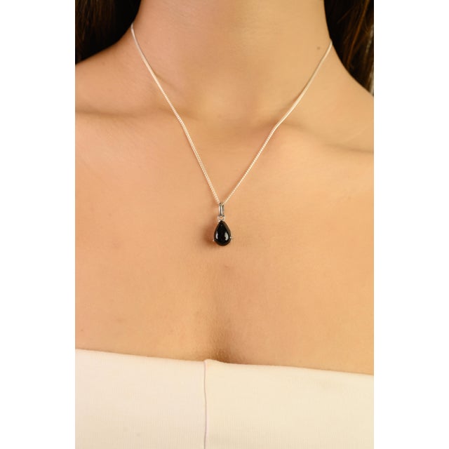 This versatile pear-cut black onyx charm pendant is beautifully set in 925 sterling silver, combining elegance with...