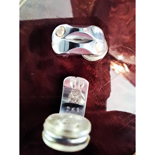 Each clip featuring two orange coloured moonstones. This piece has an attribution mark, I am sure that it is completely...