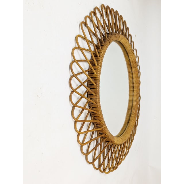 Round wall mirror with hand crafted frame, manufactured in Italy around the 1960. Very good vintage condition.