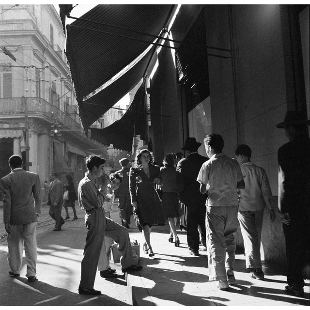 Havana HAVANA - JANUARY 1946: A women walks down a busy sidewalk in Havana. (Photo by Earl Leaf/Michael Ochs...