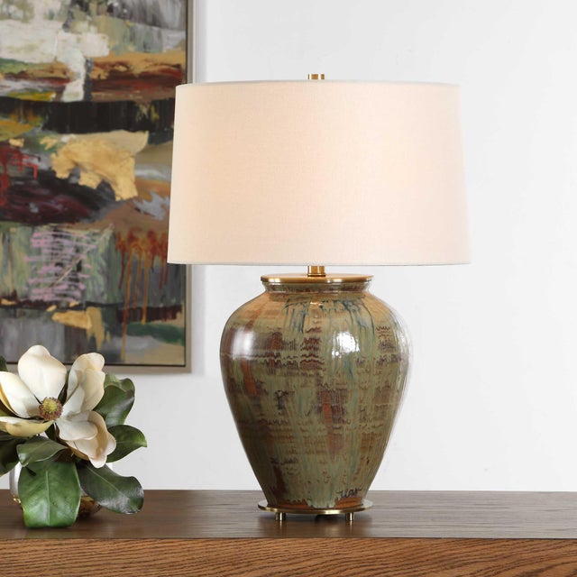 The Olisa Table Lamp Showcases A Timeless Ceramic Urn Base Finished In Shades Of Green, Blue-green, And Earthy Browns,...