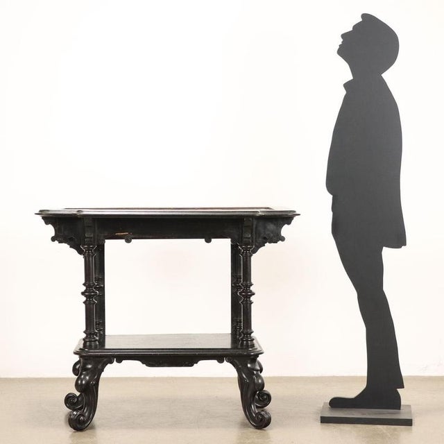 Louis Philippe flower stand in ebonized walnut supported by turned legs and wavy feet with carvings of scrolls culminating...