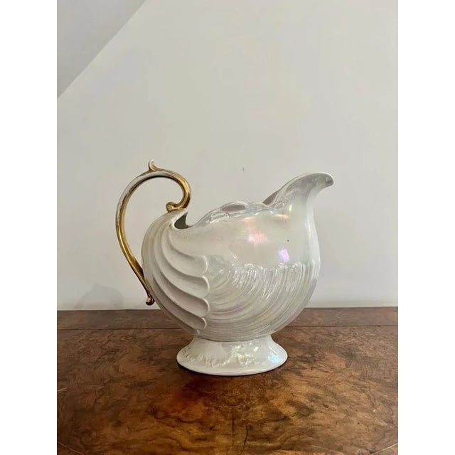 Lovely antique Edwardian Shelley jug and bowl set having a wonderful pearl shimmer ground with a gold shaped handle to the...