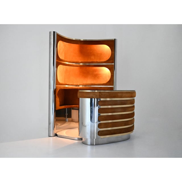The set includes a cabinet with three illuminated shelves in suede, chrome-plated metal, and brass. It also includes a...