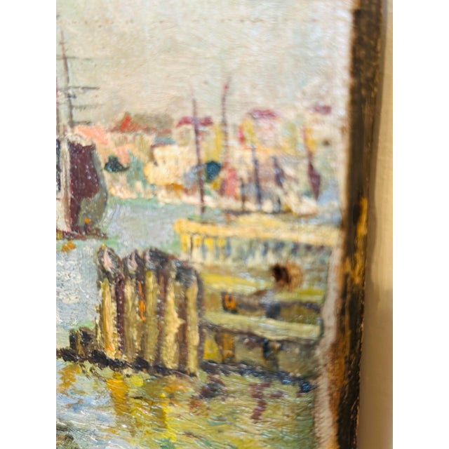 Charming antique coastal oil painting on canvas depicting a bustling harbor with colorful sailboats, shimmering blue...