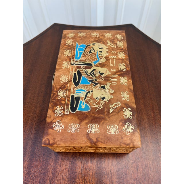 Leather jewelry box with embossed Egyptian decorative motifs. Beautiful tanned leather constructs the outside of the box...