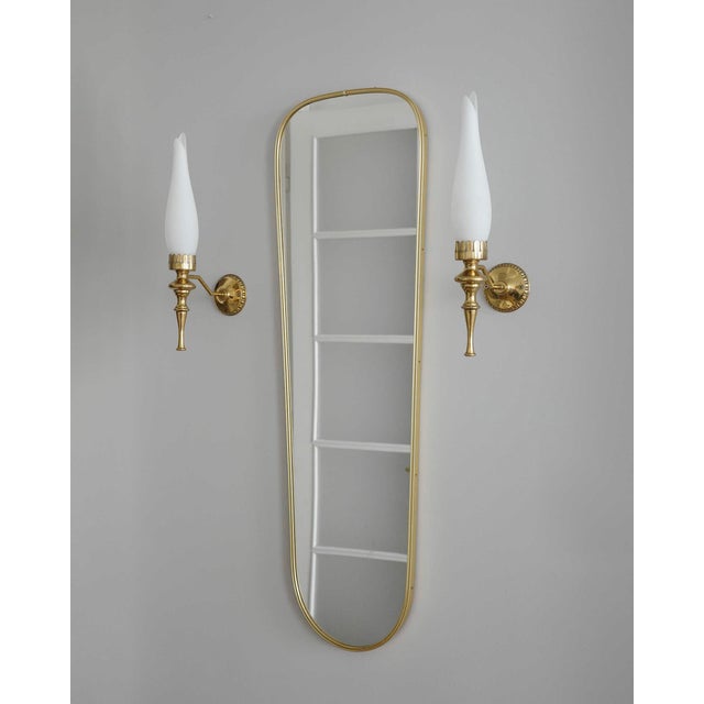 The lamps were sourced in Italy. They have a brass structure and a shade made of matte opal glass in white. Their shape...