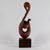 This sculpture was created by the Ecuadorian artist Luis Potosi. It depicts a swan-like figure with a looped body and a...