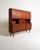 Danish teak highboard from the 1960s, with sliding doors, four drawers, pull-out trays, and a bar with a decorated mirror....