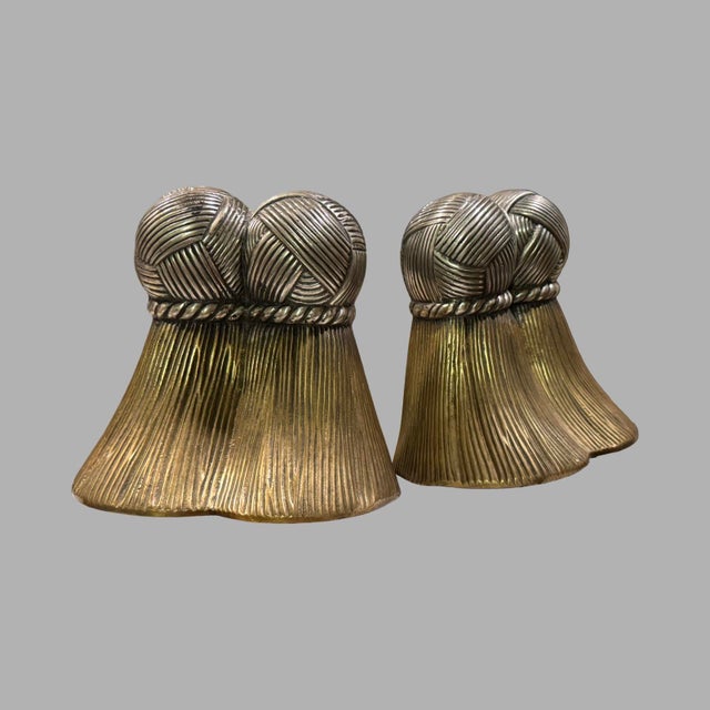 Pair of almost solid brass bookends in tassel form. Top is pewter or silver metal cast over the brass. Very heavy.