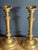A pair of French brass candlesticks, 19th century. Turned baluster form with a tapered column stem, knopped collar, and a...