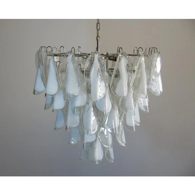 Italian vintage murano chandelier made by 50 glass petals "rondini" (transparent and white “lattimo”) in a chrome frame....