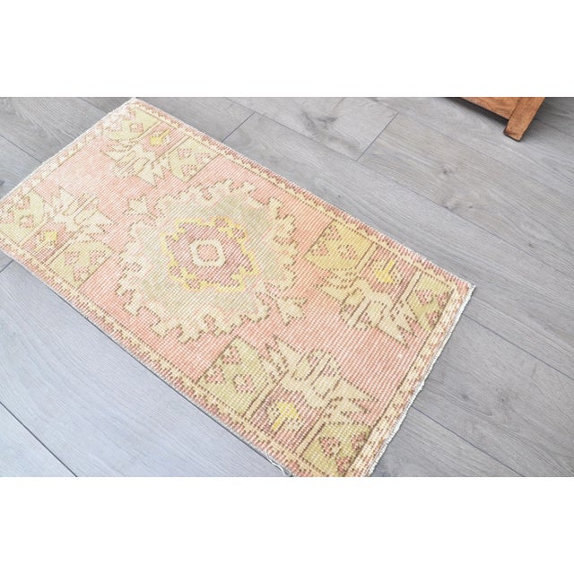 This is a vintage Turkish Oushak rug from the 1960s. The piece was hand-knotted.