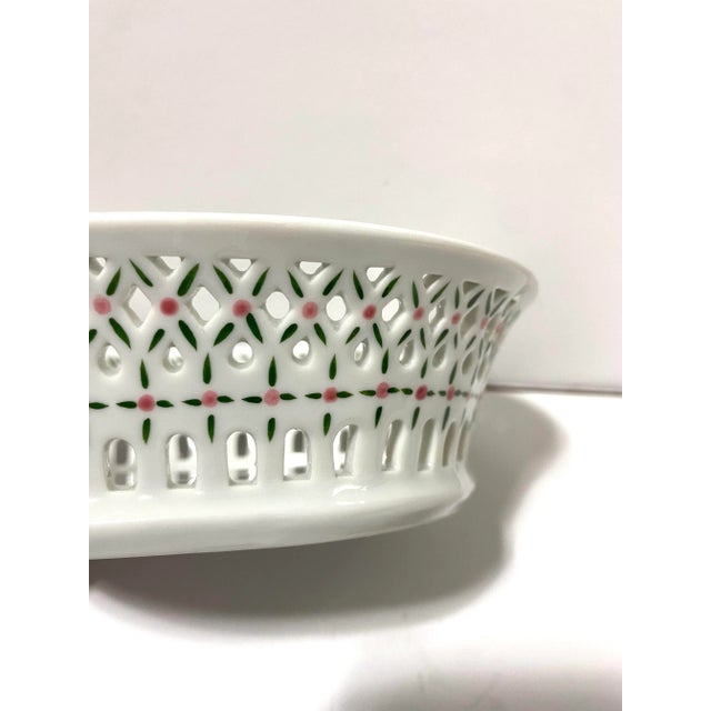 A charming vintage porcelain soap dish featuring delicate pierced latticework and classic basketweave detailing. The open...