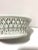 A charming vintage porcelain soap dish featuring delicate pierced latticework and classic basketweave detailing. The open...