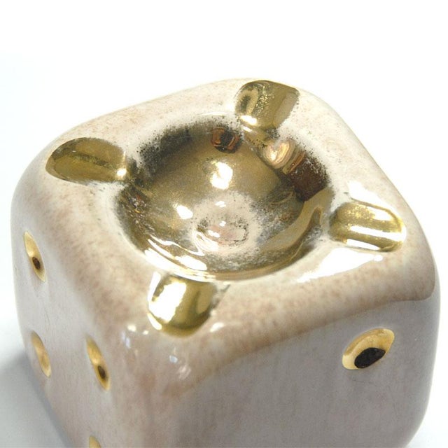 Ceramic ashtray in the shape of a dice. Glazed and gilded in places. Comes from France. It was produced in the 1960s....