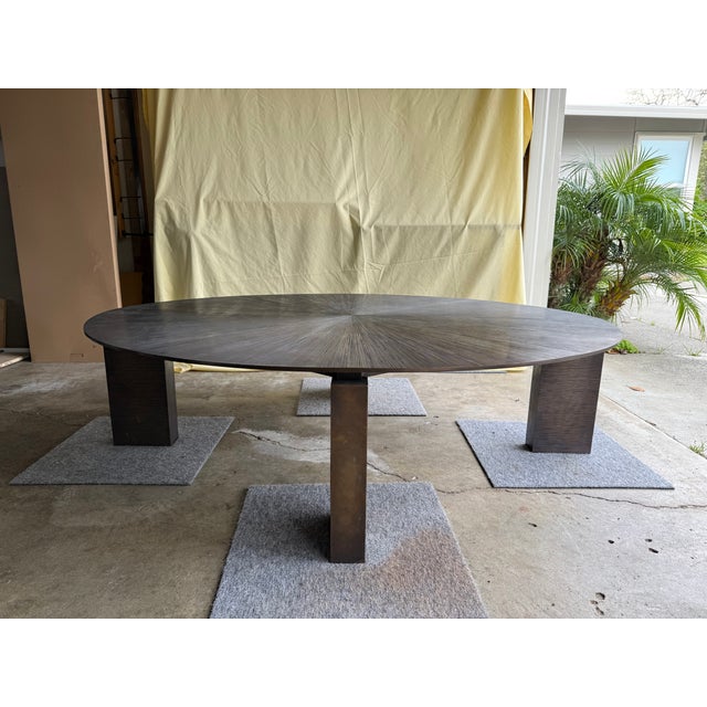 This is an iconic modern/transitional cocktail table. Completely bespoke lost wax cast bronze top and base with iron tie...