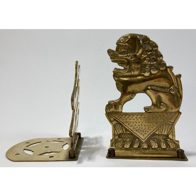 Pair of vintage flip down brass bookends with Asian motif. One features Asian symbol for good luck, the other a detailed...