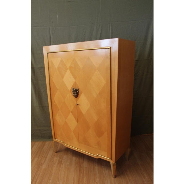 1960s sideboard attributed to the Jansen company in sycamore veneer, minor losses and wear to note base and door frames...
