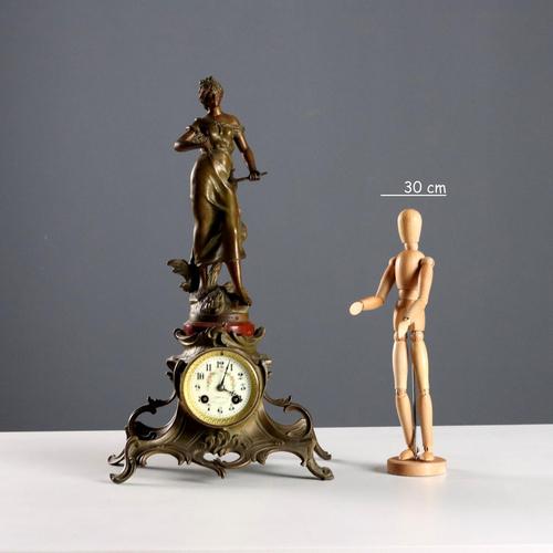 Antimony table clock surmounted by a statue of Auguste Moreau depicting the allegory of the harvest. Dial with Arabic...