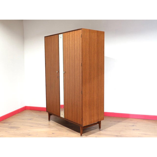 A wonderful example of mid century style, this Mid Century Modern Vintage Teak Armoire Wardrobe by Meredew Danish Style...