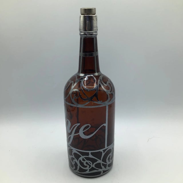 Turn-of-the-century Art Nouveau amber glass bottle decanter with engraved silver overlay. Made by La Pierre in New York....