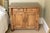 An antique French Provincial style pine side cabinet with a overhanding molded top, two upper drawers, two lower cabinet...