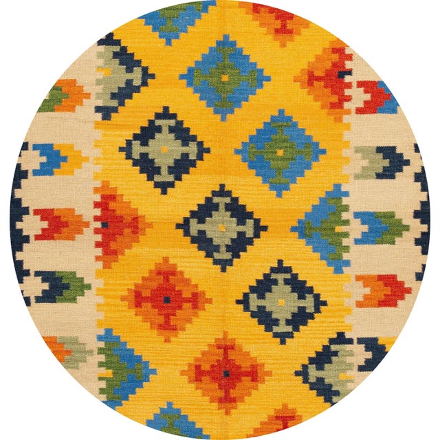 A beautiful hand-woven modern Kilim rug with a yellow field, an ivory frame, and multi-color accents in an all-over...