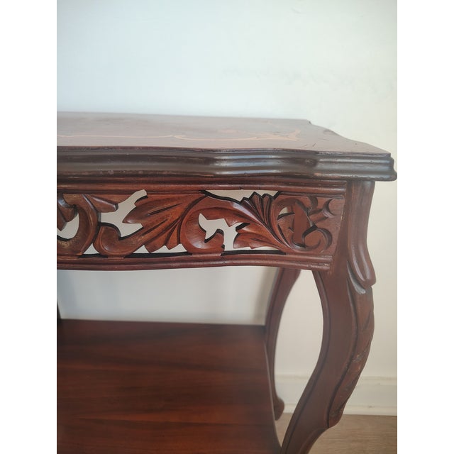 This French Louis XV style accent table features a beautifully book-matched walnut veneer top adorned with intricate,...