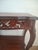 This French Louis XV style accent table features a beautifully book-matched walnut veneer top adorned with intricate,...