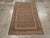A vintage East Turkestan Samarkand throw rug handmade during the Mid-20th century. Measures: 3' 4" x 5' 5"